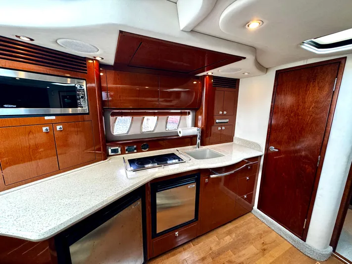  Yacht Photos Pics Luxurious kitchen interior of 2010 Sea Ray 40 Sundancer yacht with modern appliances.