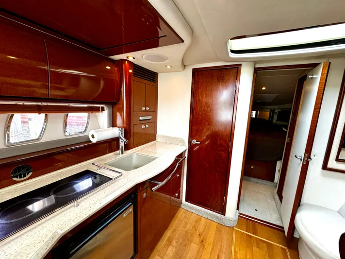  Yacht Photos Pics Luxurious interior of 2010 Sea Ray 40 Sundancer yacht with modern kitchen amenities.