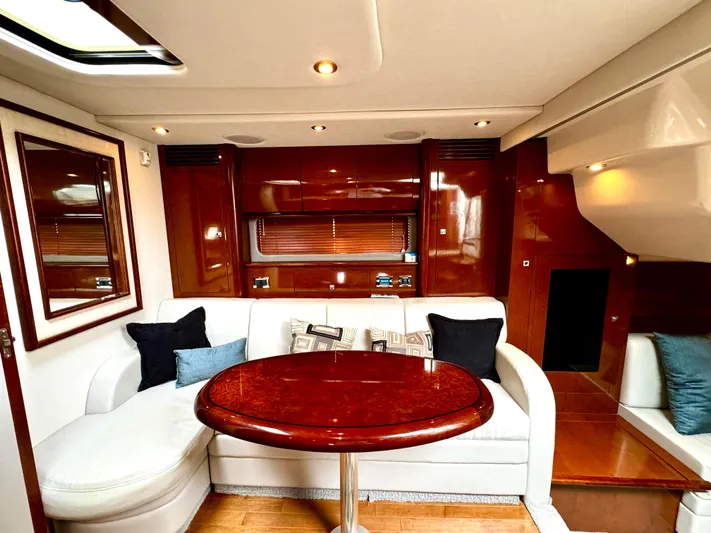  Yacht Photos Pics Luxurious interior of 2010 Sea Ray 40 Sundancer yacht with elegant seating and wooden finishes.