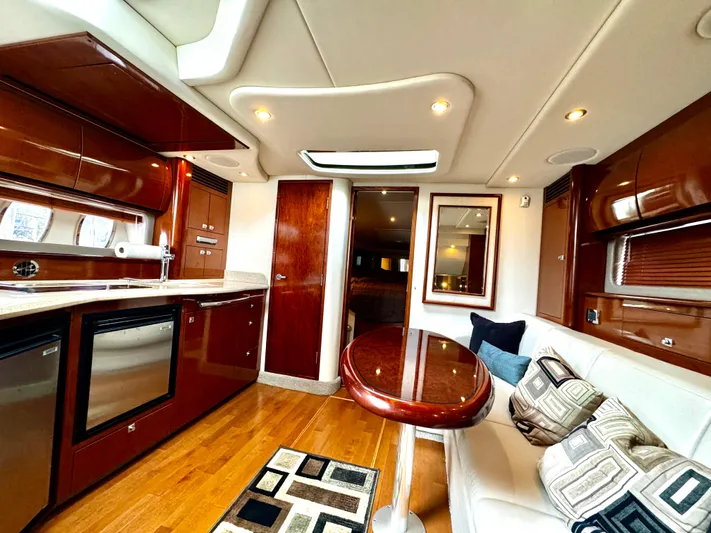  Yacht Photos Pics Luxurious interior of 2010 Sea Ray 40 Sundancer yacht with modern kitchen and seating area.