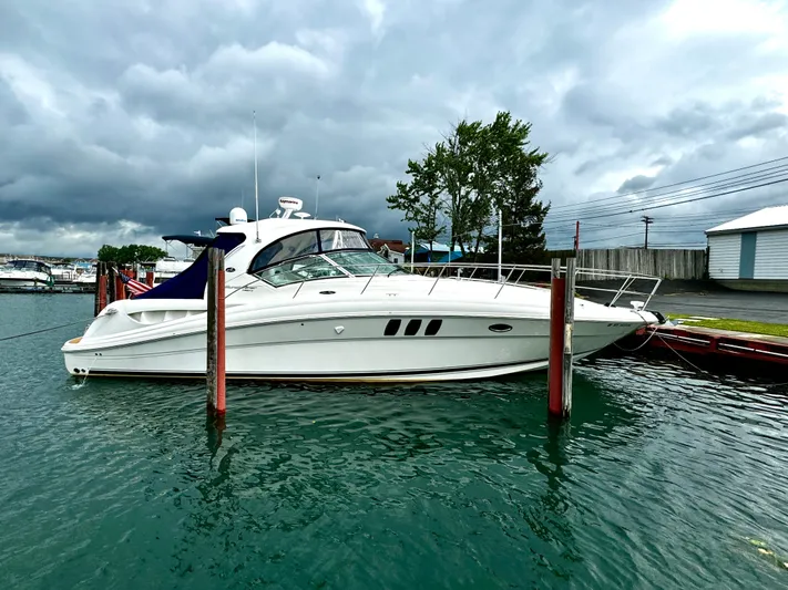  Yacht Photos Pics 2010 Sea Ray 40 Sundancer yacht docked in a marina under cloudy skies.
