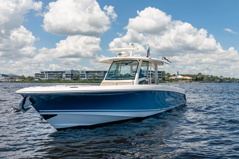 Crushed It Yacht Photos Pics 2018 Boston Whaler 380 Outrage boat on water under blue sky with clouds.
