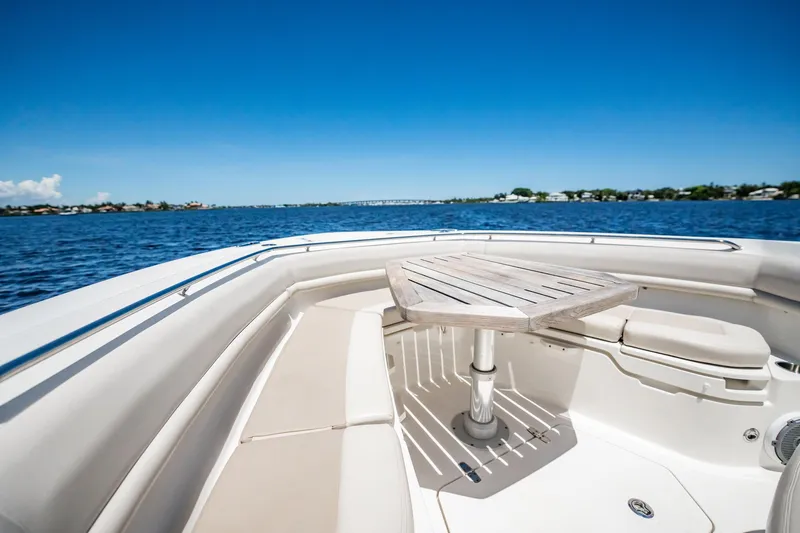 Crushed It Yacht Photos Pics 2018 Boston Whaler 380 Outrage boat interior with table on calm water.