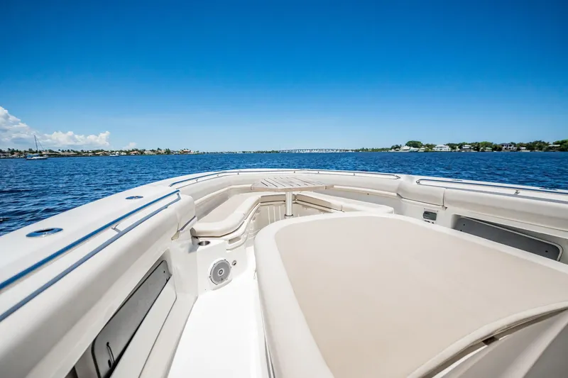 Crushed It Yacht Photos Pics 2018 Boston Whaler 380 Outrage boat on calm water, featuring spacious seating and clear blue skies.
