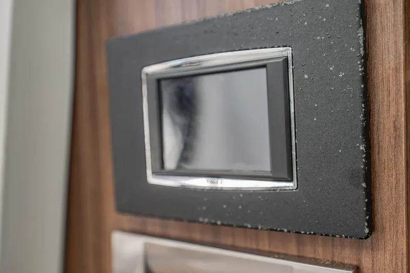 Crushed It Yacht Photos Pics Control panel on 2018 Boston Whaler 380 Outrage boat, featuring sleek design and wood finish.