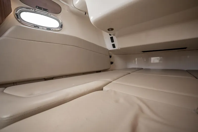 Crushed It Yacht Photos Pics Interior cabin of 2018 Boston Whaler 380 Outrage with beige seating and porthole window.