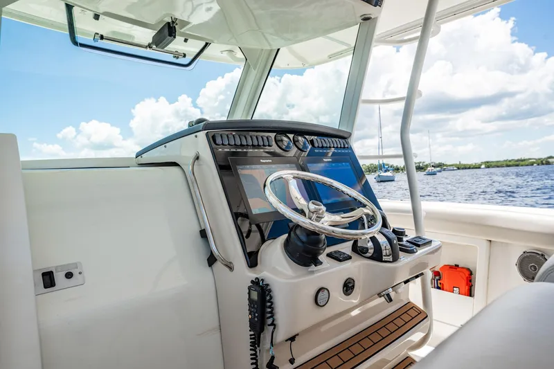Crushed It Yacht Photos Pics 2018 Boston Whaler 380 Outrage helm with modern controls and scenic water view.