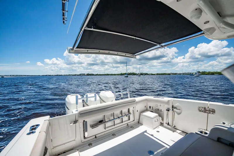 Crushed It Yacht Photos Pics 2018 Boston Whaler 380 Outrage boat on open water, featuring spacious deck and canopy.