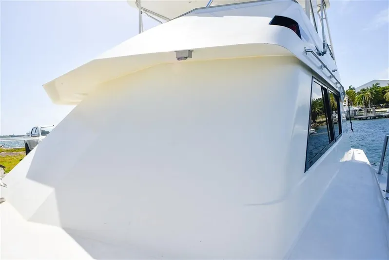  Yacht Photos Pics 1987 Hatteras Sportfish yacht, sleek white exterior, docked by the water.