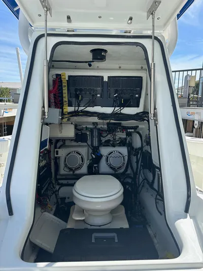  Yacht Photos Pics 2012 Yellowfin 36 Offshore boat interior with toilet and electronic equipment.