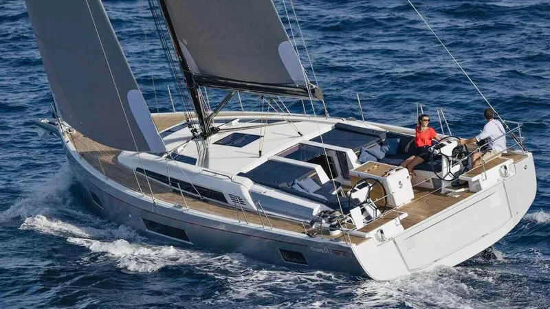1725 Yacht Photos Pics 2022 Beneteau Oceanis 51.1 sailing on open sea, featuring sleek design and spacious deck.