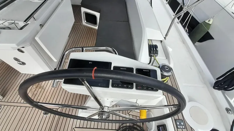 1725 Yacht Photos Pics Cockpit of 2022 Beneteau Oceanis 51.1 yacht with steering wheel and navigation controls.