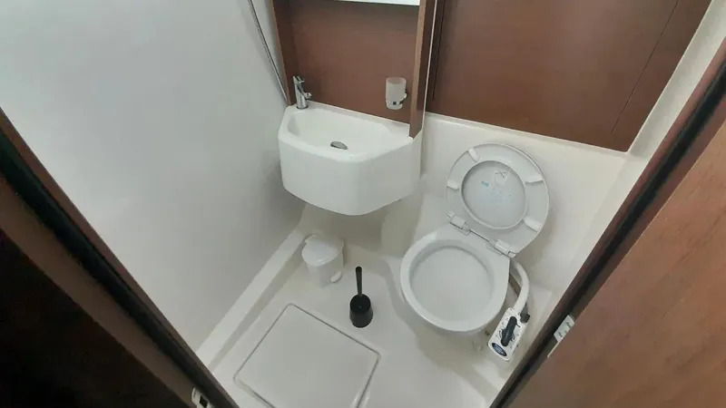 1725 Yacht Photos Pics Bathroom interior of 2022 Beneteau Oceanis 51.1 yacht, featuring sink and toilet.