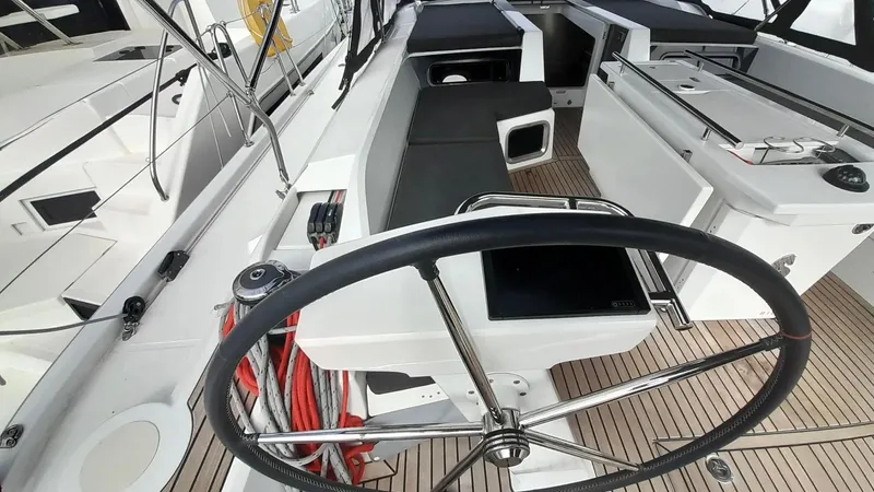 1725 Yacht Photos Pics Cockpit of 2022 Beneteau Oceanis 51.1 yacht with steering wheel and seating area.