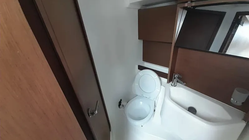 1725 Yacht Photos Pics Bathroom interior of 2022 Beneteau Oceanis 51.1 yacht, featuring modern fixtures and wood accents.