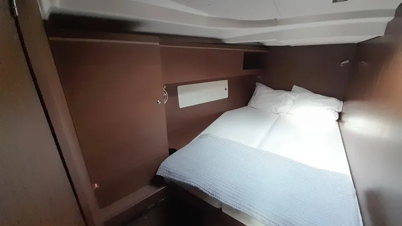 1725 Yacht Photos Pics Cozy cabin interior of 2022 Beneteau Oceanis 51.1 yacht with comfortable bedding.