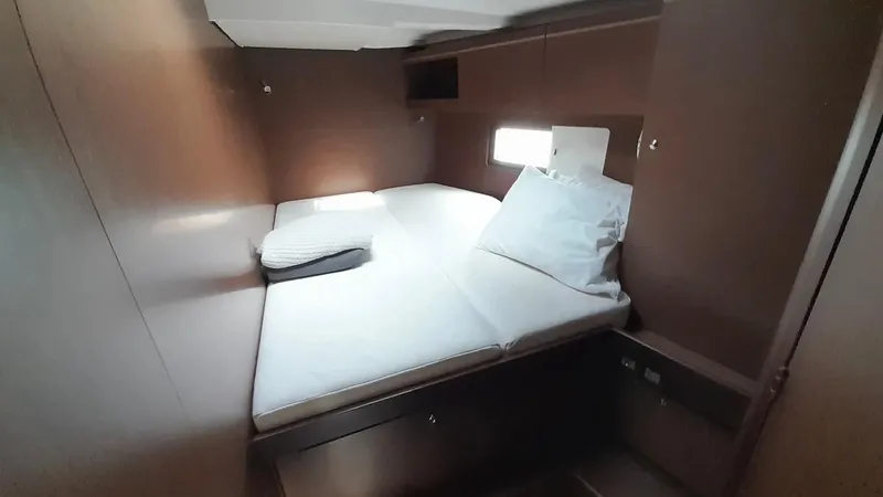 1725 Yacht Photos Pics Cozy cabin interior of 2022 Beneteau Oceanis 51.1 yacht with bed and window.
