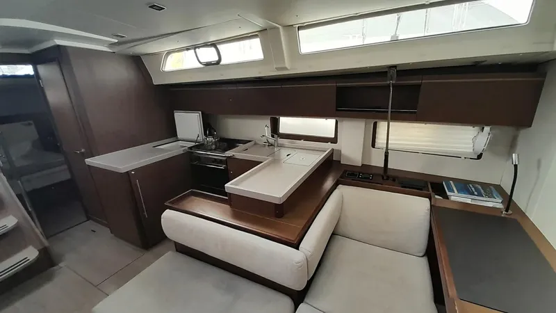 1725 Yacht Photos Pics Luxurious interior of 2022 Beneteau Oceanis 51.1 yacht with modern kitchen and seating area.