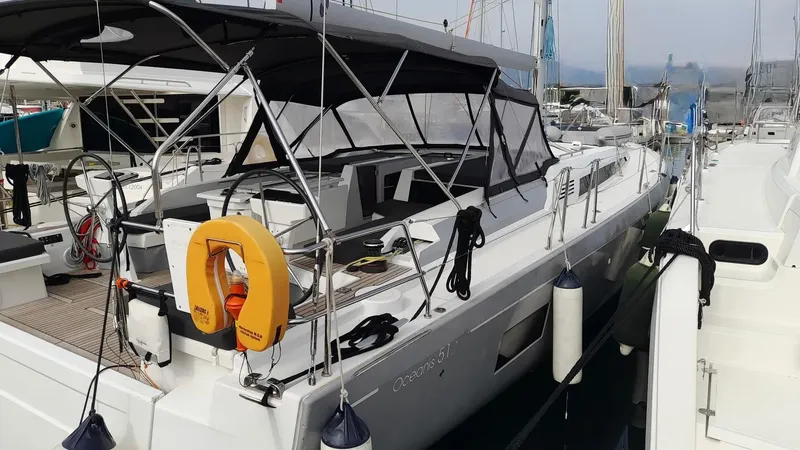1725 Yacht Photos Pics 2022 Beneteau Oceanis 51.1 yacht docked at marina, featuring sleek design and spacious deck.