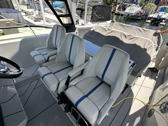 Ostende Yacht Photos Pics 2022 Saxdor 320 GTO boat interior with modern seating and steering wheel.