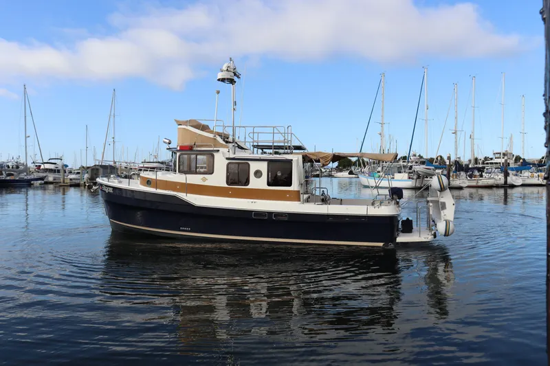 Sequel Yacht Photos Pics 2015 Ranger Tugs R-31 CB boat docked in a marina with clear blue skies.