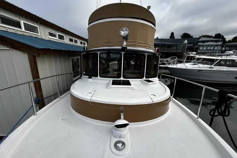 Sequel Yacht Photos Pics 2015 Ranger Tugs R-31 CB boat docked at marina, overcast sky.