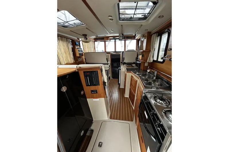 Sequel Yacht Photos Pics Interior of 2015 Ranger Tugs R-31 CB, featuring kitchen and seating area.