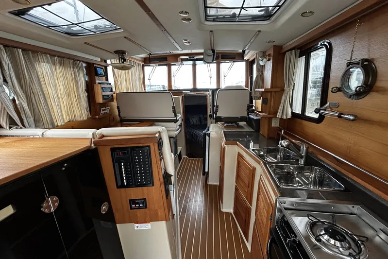 Sequel Yacht Photos Pics Interior of 2015 Ranger Tugs R-31 CB, featuring wood accents and modern amenities.