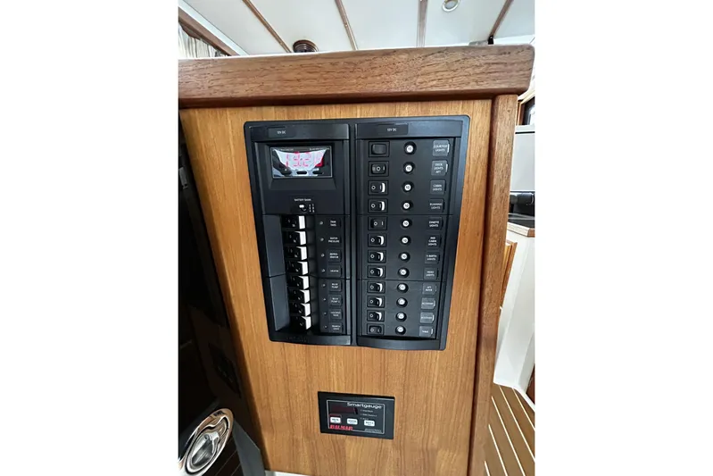 Sequel Yacht Photos Pics 2015 Ranger Tugs R-31 CB electrical panel with switches and display on wooden interior.