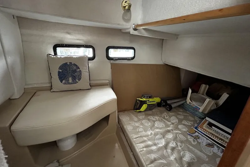 Sequel Yacht Photos Pics 2015 Ranger Tugs R-31 CB cabin interior with seating, cushion, and tools.