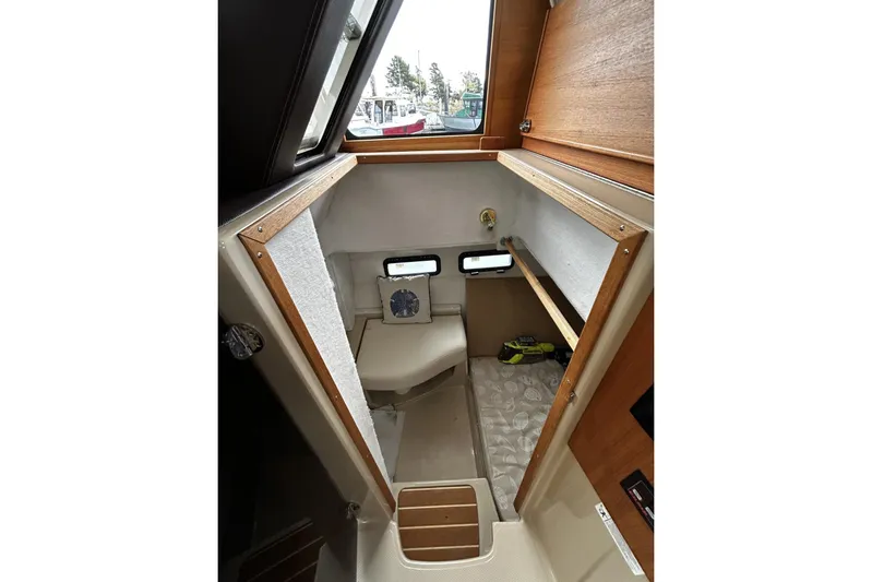 Sequel Yacht Photos Pics 2015 Ranger Tugs R-31 CB cabin interior with wooden accents and compact design.