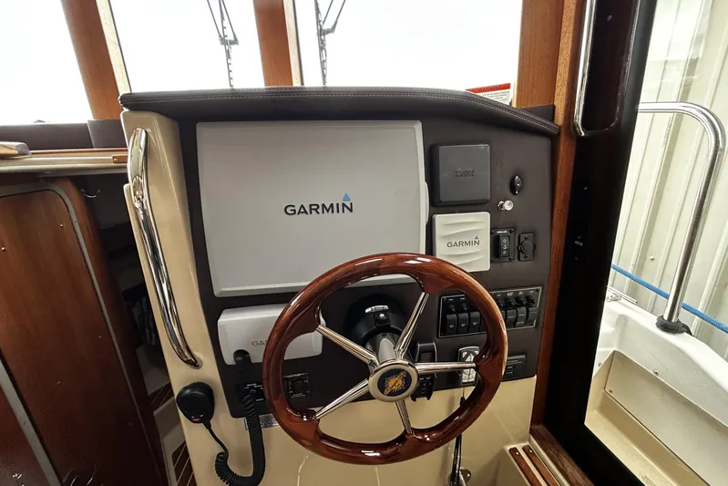 Sequel Yacht Photos Pics 2015 Ranger Tugs R-31 CB helm with Garmin navigation system and wooden steering wheel.