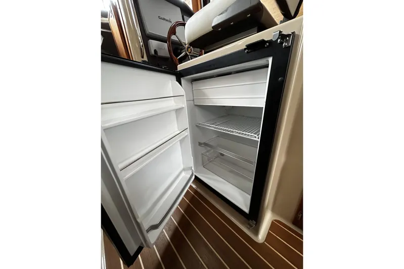 Sequel Yacht Photos Pics Open refrigerator inside 2015 Ranger Tugs R-31 CB boat, showcasing interior storage space.