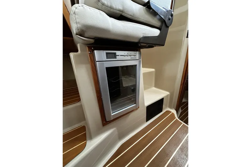 Sequel Yacht Photos Pics 2015 Ranger Tugs R-31 CB interior with built-in refrigerator and wooden flooring.