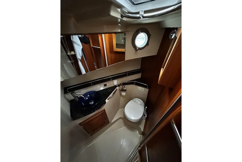 Sequel Yacht Photos Pics 2015 Ranger Tugs R-31 CB bathroom with porthole, sink, and toilet.