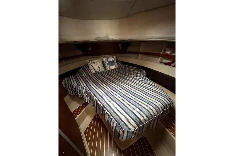 Sequel Yacht Photos Pics Cozy cabin interior of 2015 Ranger Tugs R-31 CB with striped bedding and nautical decor.