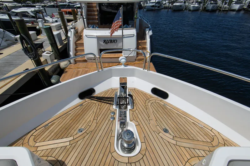  Yacht Photos Pics Sunseeker 76 Yacht 2020 with teak deck, docked at marina, rear view.