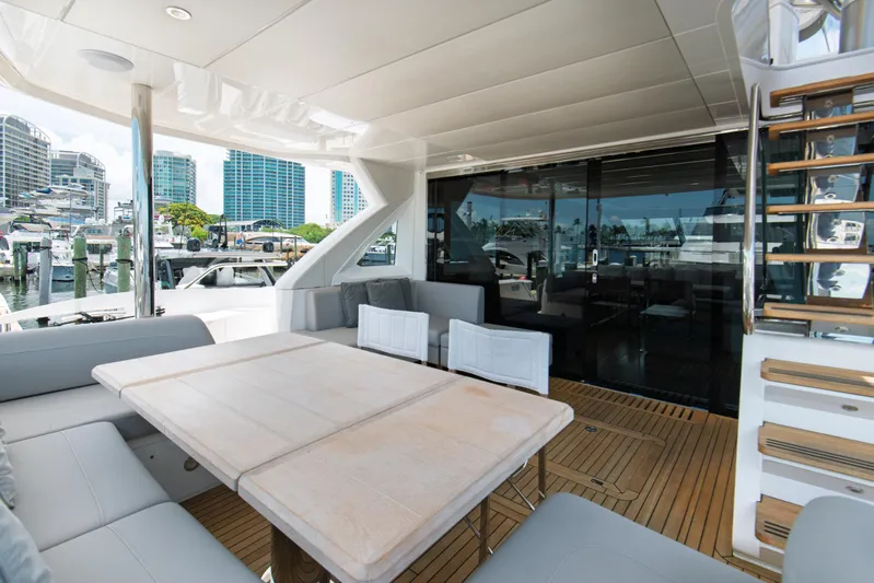  Yacht Photos Pics Luxurious Sunseeker 76 Yacht 2020 with elegant outdoor seating and marina view.