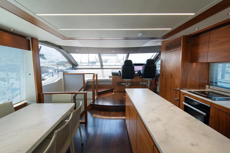  Yacht Photos Pics Luxurious interior of 2020 Sunseeker 76 Yacht with modern kitchen and helm station.