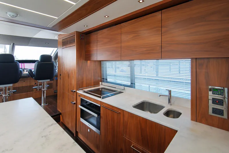  Yacht Photos Pics Luxurious Sunseeker 76 Yacht 2020 kitchen with sleek wood cabinetry and modern appliances.
