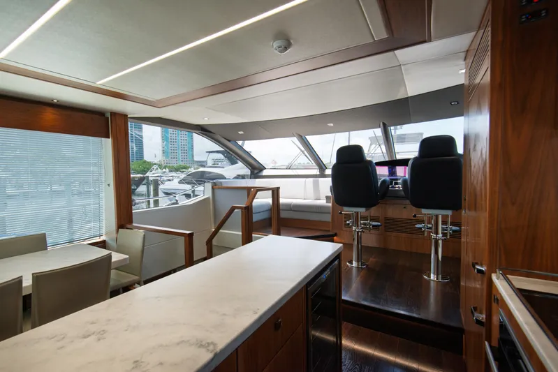  Yacht Photos Pics Luxurious interior of 2020 Sunseeker 76 Yacht with modern helm and dining area.