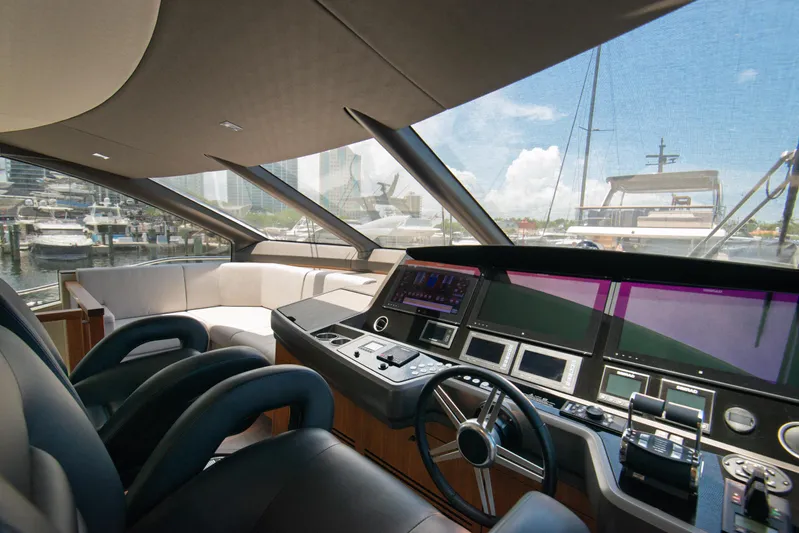  Yacht Photos Pics Luxurious 2020 Sunseeker 76 Yacht helm with modern controls and panoramic marina view.