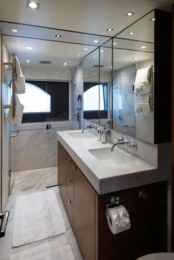  Yacht Photos Pics Luxurious bathroom in 2020 Sunseeker 76 Yacht with double sinks and marble accents.