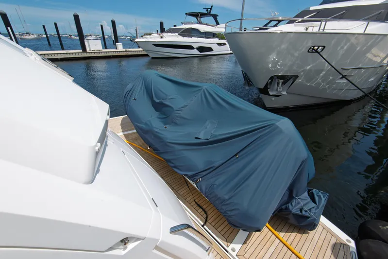  Yacht Photos Pics 2020 Sunseeker 76 Yacht docked with covered equipment on deck.