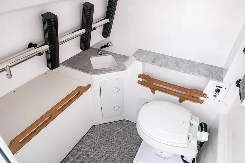 Hat Trick Yacht Photos Pics : 2021 Everglades 295 Center Console boat interior with toilet and sink.