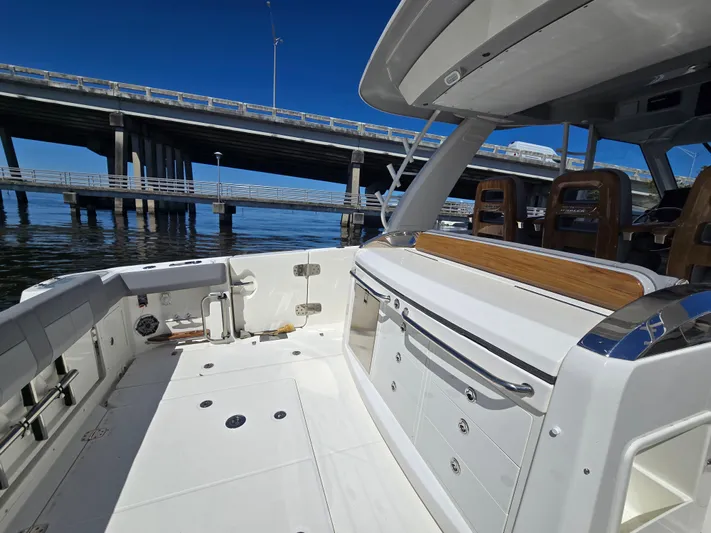  Yacht Photos Pics Boston Whaler 420 Outrage 2023 under bridge, luxury boat deck.