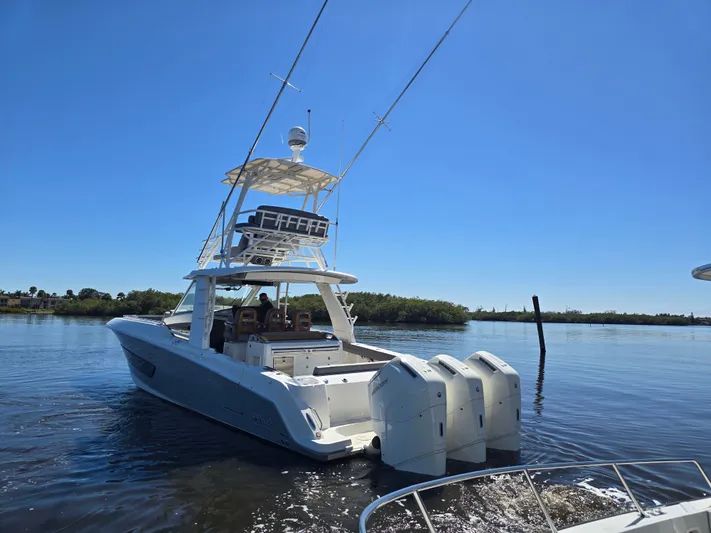  Yacht Photos Pics Boston Whaler 420 Outrage 2023 on calm water under clear sky.