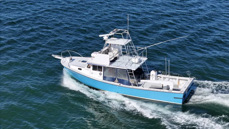 Ocean Explorer Yacht Photos Pics Custom 45 Doucette boat cruising on open water, 2006 model, blue and white design.