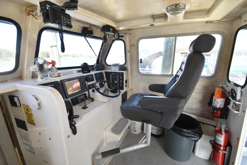 Ocean Explorer Yacht Photos Pics Interior of 2006 Custom 45 Doucette boat cockpit with navigation equipment and captain's chair.