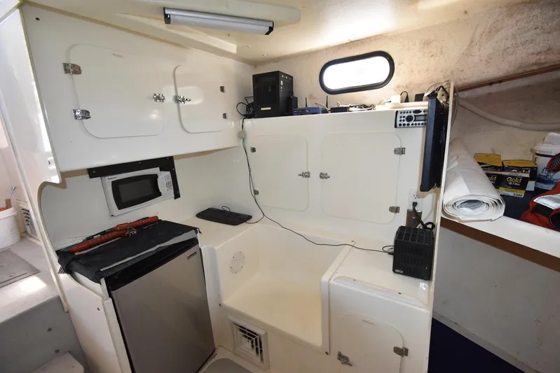 Ocean Explorer Yacht Photos Pics Interior of a 2006 Custom 45 Doucette boat with kitchenette and storage cabinets.